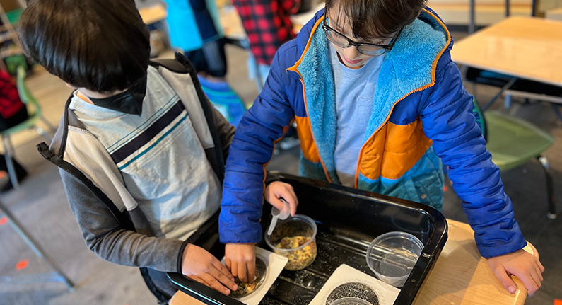 2 children engaged in a science experiment