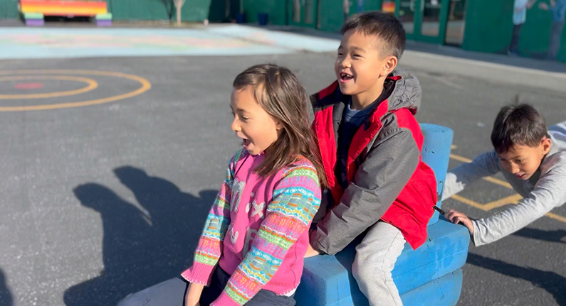 3 children on a playground having fun